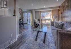 Living room with dark wood-type flooring and a textured ceiling - 