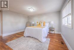 Bedroom with a textured ceiling and dark hardwood / wood-style flooring - 