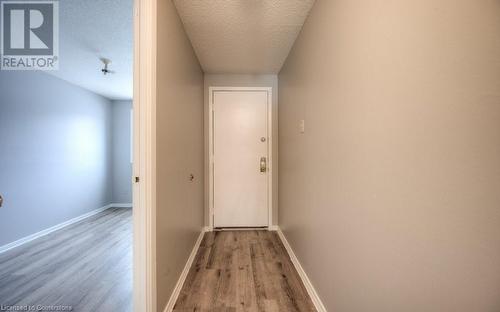 Hallway with light hardwood / wood-style floors and a textured ceiling - 1200 Courtland Avenue E Unit# 27, Kitchener, ON - Indoor Photo Showing Other Room