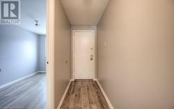 Hallway with light hardwood / wood-style floors and a textured ceiling - 