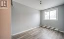 Spare room with baseboard heating and light wood-type flooring - 1200 Courtland Avenue E Unit# 27, Kitchener, ON  - Indoor Photo Showing Other Room 