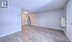 Spare room featuring light wood-type flooring, a textured ceiling, and heating unit - 