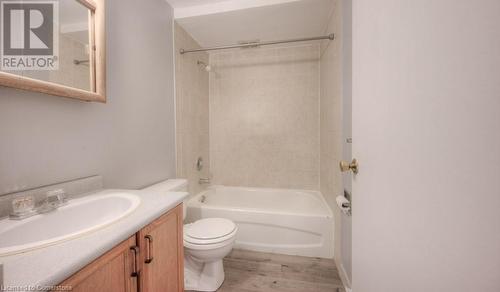 Full bathroom with vanity, toilet, wood-type flooring, and tiled shower / bath combo - 1200 Courtland Avenue E Unit# 27, Kitchener, ON - Indoor Photo Showing Bathroom