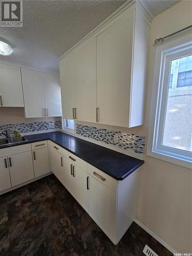 813 Souris Avenue, Weyburn, SK - Indoor Photo Showing Kitchen With Double Sink