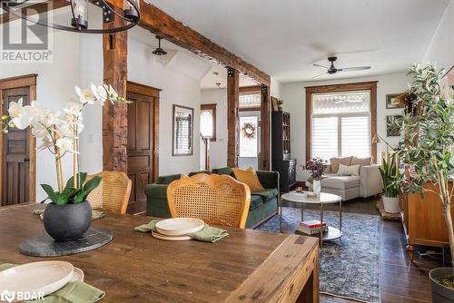 Dining room featuring dark hardwood flooring, ceiling fan with notable chandelier, and lofted ceiling with beams - 109 Fairleigh Avenue S, Hamilton, ON - Indoor Photo Showing Other Room