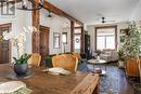 Dining room featuring dark hardwood flooring, ceiling fan with notable chandelier, and lofted ceiling with beams - 109 Fairleigh Avenue S, Hamilton, ON  - Indoor Photo Showing Other Room 