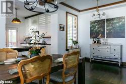 Dining room with hardwood floors, an inviting chandelier, and ornamental molding - 