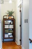 Corridor featuring ornamental molding and hardwood flooring - 