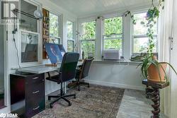 Office with wood flooring, cooling unit, and ornamental molding - 