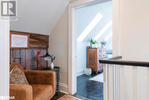 Living area with dark wood flooring and vaulted ceiling with skylight - 109 Fairleigh Avenue S, Hamilton, ON - Indoor Photo Showing Other Room