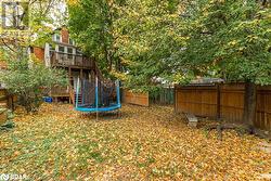 View of yard with a trampoline and a deck - 