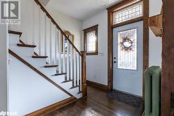 Entrance foyer with dark wood flooring and radiator - 