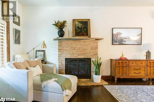 Living room with dark hardwood flooring + fireplace - 109 Fairleigh Avenue S, Hamilton, ON - Indoor With Fireplace