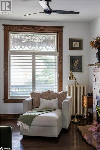 Sitting room with hardwood flooring and radiator - 109 Fairleigh Avenue S, Hamilton, ON - Indoor Photo Showing Living Room With Fireplace