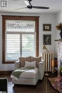 Sitting room with hardwood flooring and radiator - 