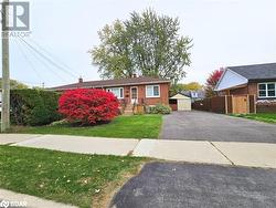 View of front facade featuring an outbuilding and a front lawn - 