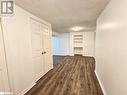 Hall featuring dark wood-type flooring and a textured ceiling - 1306 Leighland Road Unit# Ll, Burlington, ON  - Indoor Photo Showing Other Room 