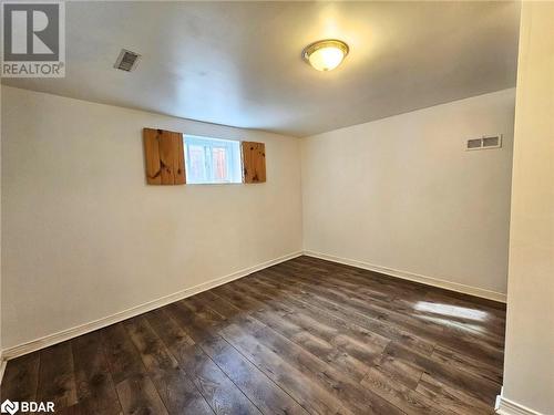 Basement with dark hardwood / wood-style flooring - 1306 Leighland Road Unit# Ll, Burlington, ON - Indoor Photo Showing Other Room