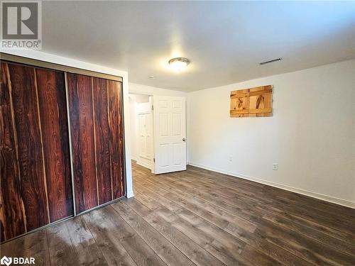 Unfurnished bedroom featuring hardwood / wood-style flooring and a closet - 1306 Leighland Road Unit# Ll, Burlington, ON - Indoor Photo Showing Other Room