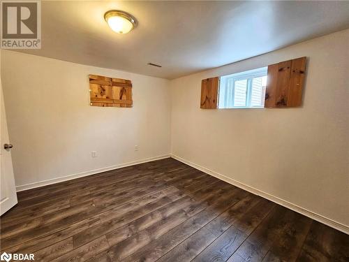 Unfurnished room with dark wood-type flooring - 1306 Leighland Road Unit# Ll, Burlington, ON - Indoor Photo Showing Other Room