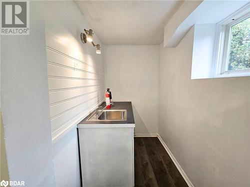 Bar with dark hardwood / wood-style flooring and sink - 1306 Leighland Road Unit# Ll, Burlington, ON - Indoor Photo Showing Laundry Room