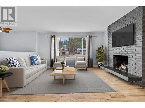 Main floor living room *virtually staged - 3309 Mcmahon Road, West Kelowna, BC - Indoor Photo Showing Living Room With Fireplace