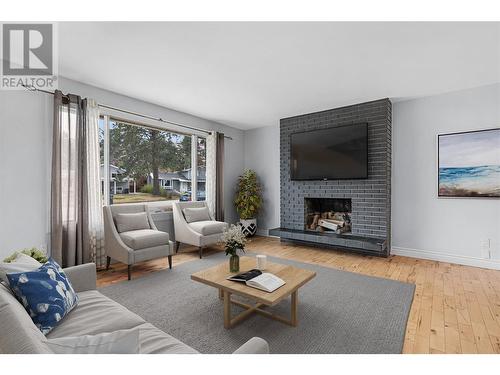 Main floor living room *virtually staged - 3309 Mcmahon Road, West Kelowna, BC - Indoor Photo Showing Living Room With Fireplace