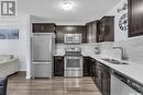 1207 130 Marlatte Crescent, Saskatoon, SK  - Indoor Photo Showing Kitchen With Stainless Steel Kitchen With Double Sink With Upgraded Kitchen 