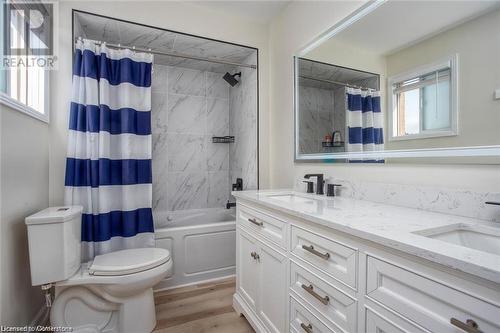 Full bathroom with toilet, vanity, shower / bath combo, and hardwood / wood-style flooring - 134 Bayne Crescent, Cambridge, ON 