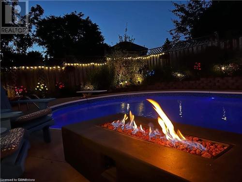 View of swimming pool with an outdoor fire pit - 134 Bayne Crescent, Cambridge, ON 