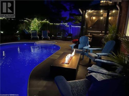 Pool at twilight with a patio area and a fire pit - 134 Bayne Crescent, Cambridge, ON 