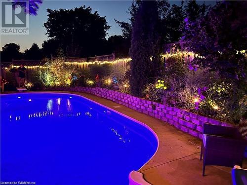 View of pool at dusk - 134 Bayne Crescent, Cambridge, ON 