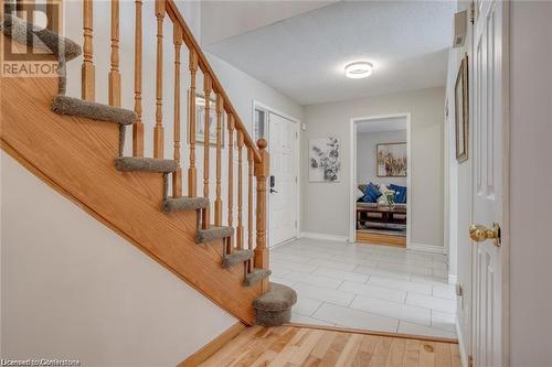 Entrance foyer with wood-type flooring and a textured ceiling - 134 Bayne Crescent, Cambridge, ON 