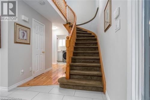 Stairway featuring washer / dryer and hardwood / wood-style floors - 134 Bayne Crescent, Cambridge, ON 