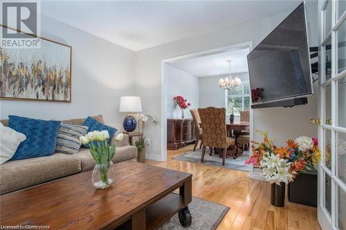 Living room featuring hardwood / wood-style floors and a notable chandelier - 134 Bayne Crescent, Cambridge, ON 