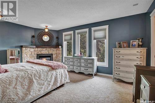 414 Charlebois Court, Saskatoon, SK - Indoor Photo Showing Bedroom With Fireplace