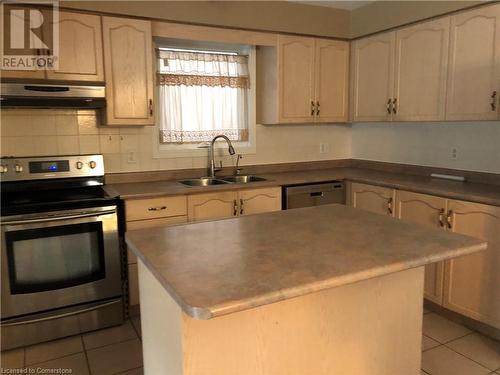 Kitchen with a center island, sink, stainless steel appliances, and exhaust hood - 356 Havendale Crescent, Waterloo, ON - Indoor Photo Showing Kitchen With Double Sink