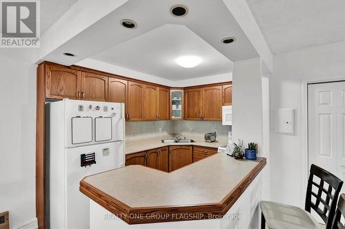 702 - 293 Mohawk Road E, Hamilton, ON - Indoor Photo Showing Kitchen With Double Sink