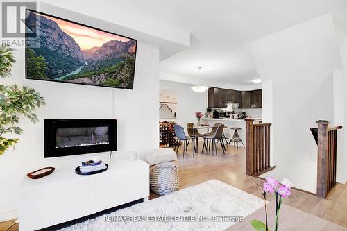 54 - 1222 Rose Way, Milton, ON - Indoor Photo Showing Living Room With Fireplace