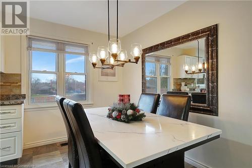 Dining area featuring a healthy amount of sunlight and an inviting chandelier - 362 Blair Road, Cambridge, ON - Indoor Photo Showing Dining Room