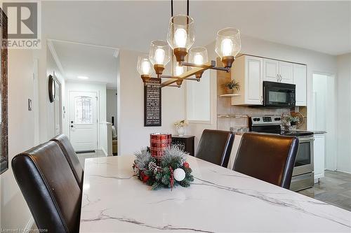 Dining area featuring a notable chandelier and light hardwood / wood-style flooring - 362 Blair Road, Cambridge, ON - Indoor Photo Showing Dining Room