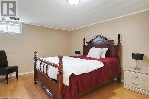 Bedroom with light wood-type flooring and ornamental molding - 362 Blair Road, Cambridge, ON - Indoor Photo Showing Bedroom