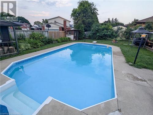 View of pool featuring a gazebo, a storage unit, and a lawn - 362 Blair Road, Cambridge, ON - Outdoor With In Ground Pool With Backyard