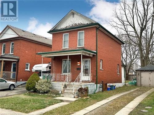 View of front of property featuring covered porch and a storage shed - 57 Lowell Street N, Cambridge, ON - Outdoor With Deck Patio Veranda