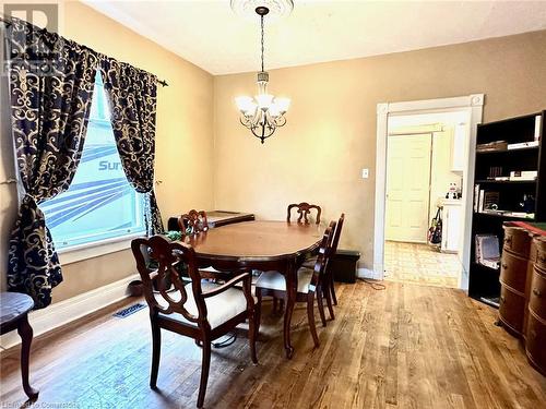 Dining area featuring hardwood / wood-style flooring and an inviting chandelier - 57 Lowell Street N, Cambridge, ON - Indoor Photo Showing Dining Room