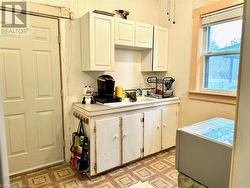 Kitchen featuring white cabinetry - 