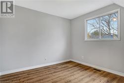 Spare room featuring light hardwood / wood-style floors and vaulted ceiling - 