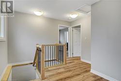 Hallway featuring a healthy amount of sunlight and light hardwood / wood-style flooring - 