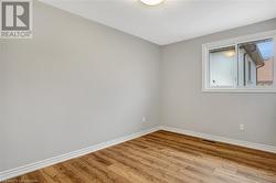 Empty room with light wood-type flooring - 