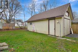 View of outdoor structure featuring a lawn - 